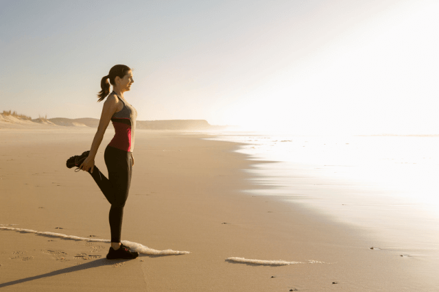 woman exercising at the beach