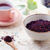 loose aronia fruit tea with spoon and cup